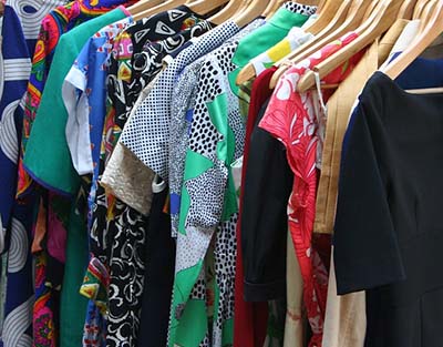 clothes hanging on racks in a store